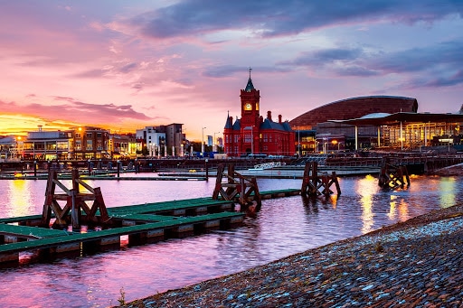 Cardiff waterfront with a colourful sky at night.
