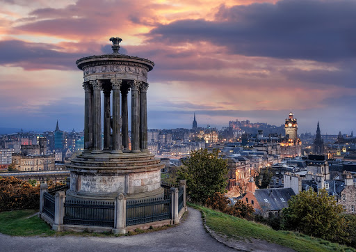 Panoramic image of Edinburgh Scotland against sunset on Calton Hill.