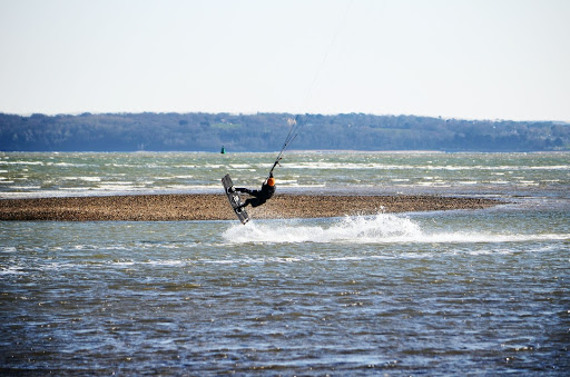 Person kitesurfing on the coast in Southampton, England.