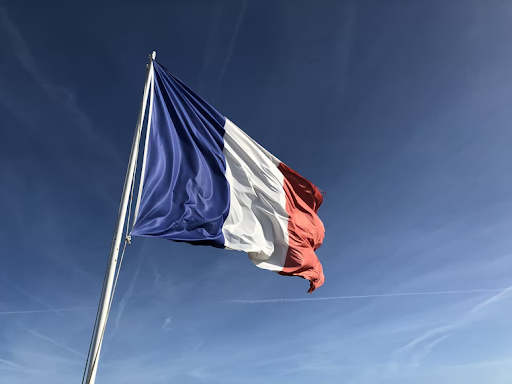 French flag with blue sky in the background