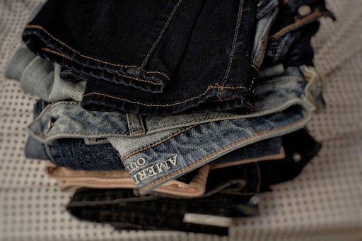 Pile of jeans and clothes on the bed Pile of jeans and clothes on the bed