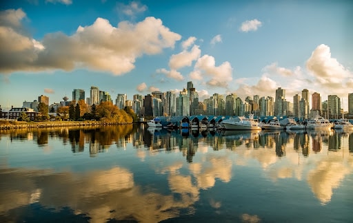 View of Vancouver’s skyline from the water with clouds reflected above and below