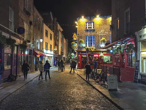 Nighttime shot of people walking in Temple Bar street in Dublin, Ireland