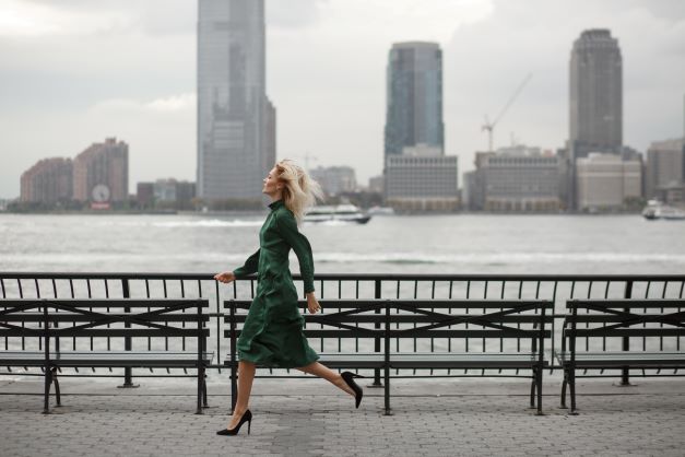 thoughtful-woman-runs-her-elegant-dress-along-river-shore-new-york