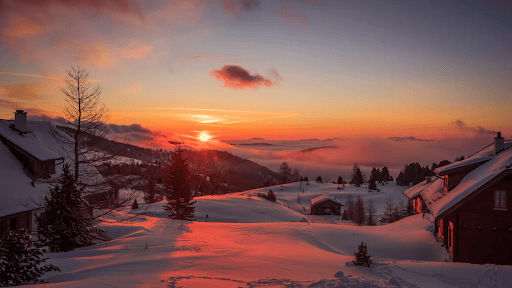 The sun rising over snowcapped mountains in Austria