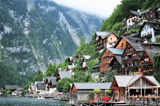 View of Hallstatt village in the mountains by a lake in Austria.