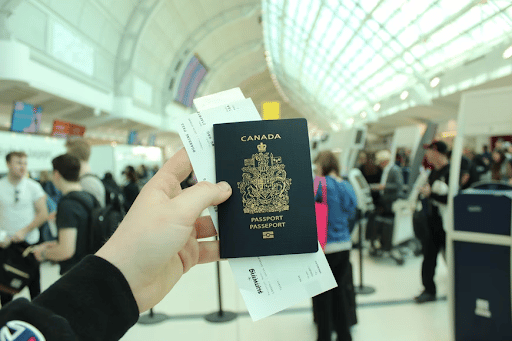 Canadian passport in a departure hall at an airport.