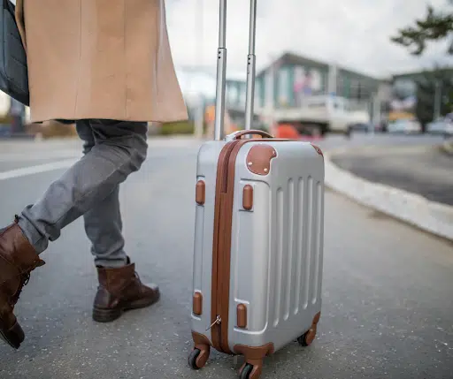 Man travelling abroad alone with his suitcase